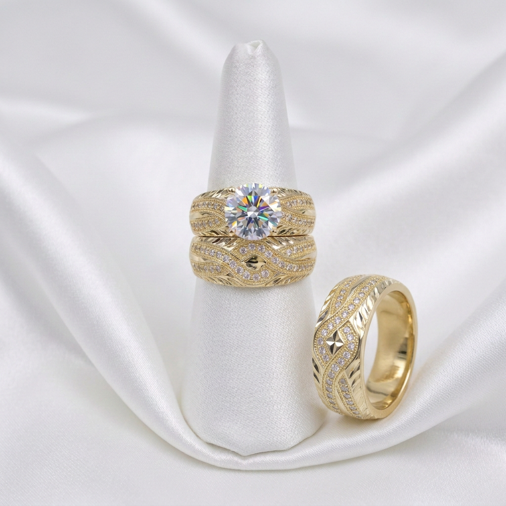 Gold wedding trio on white satin with men's ring standing beside the women's rings
